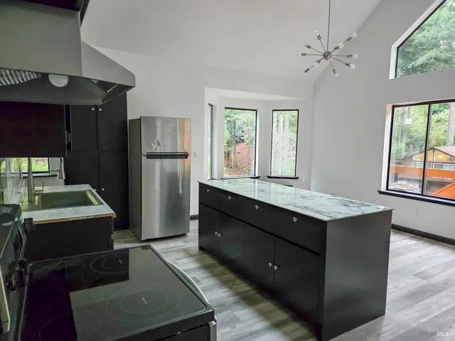 a kitchen with a refrigerator and a stove