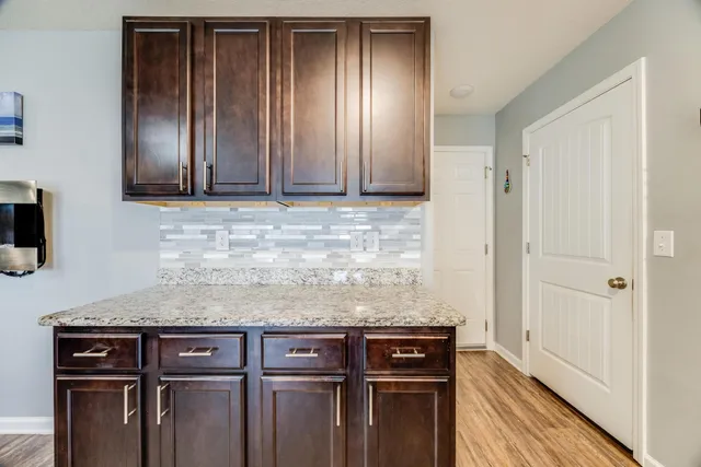 a view of a storage and utility room with wooden floor