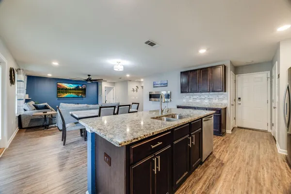 a kitchen with a stove a counter top space and cabinets