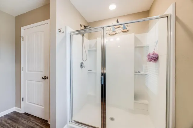 a bathroom with a glass door shower
