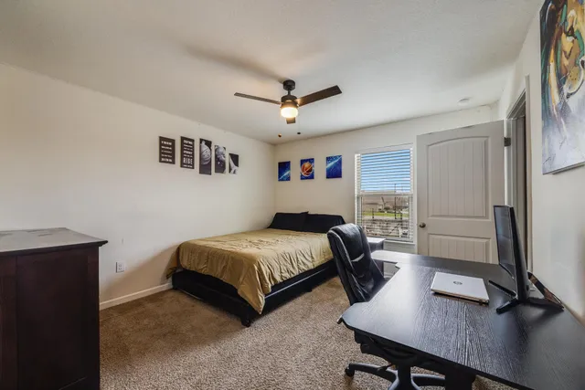 a bedroom with a bed a desk and chair