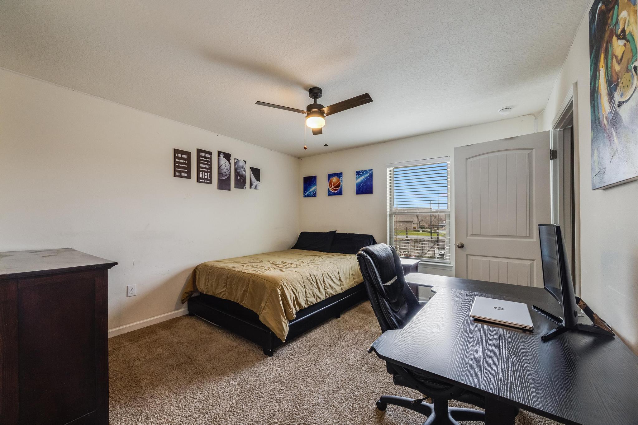 367 Merlin Court Crestview, FL 32539 - Photo 32 of 46 a bedroom with a bed a desk and chair