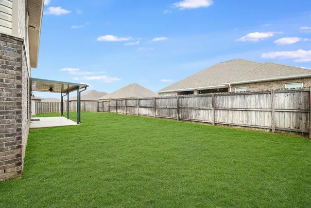 a view of a backyard with a garden and plants