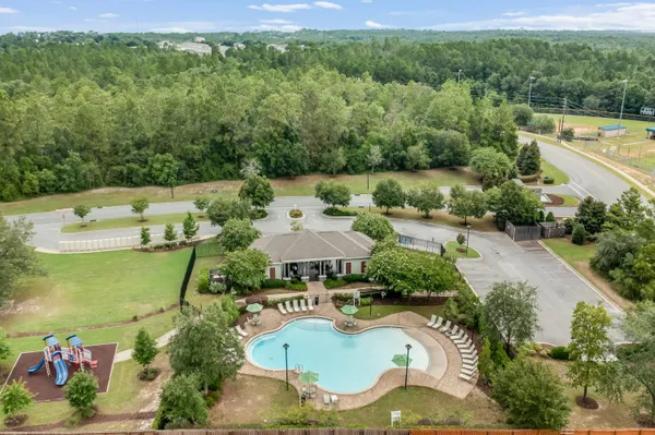an aerial view of a house with swimming pool patio and outdoor seating