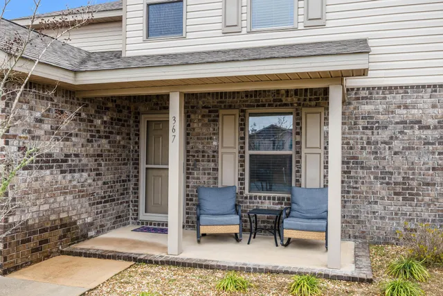 a front view of a house with outdoor seating