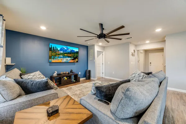 a living room with furniture and a flat screen tv