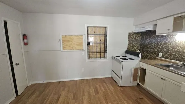 a kitchen with a stove a refrigerator and a sink