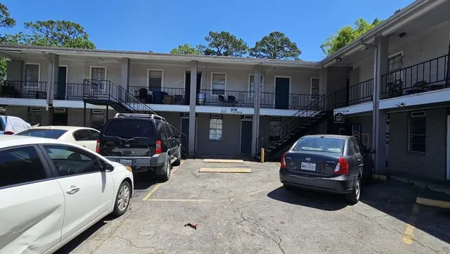 a car parked in front of white house