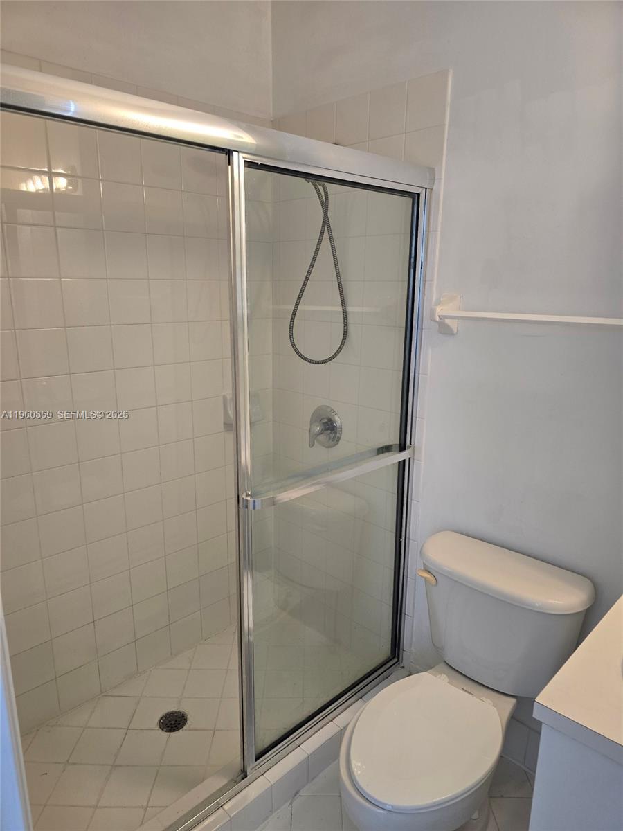 1575 Northeast 33rd Avenue, Unit 1049 Homestead, FL 33033 - Photo 14 of 22 a white toilet sitting next to a bathroom sink