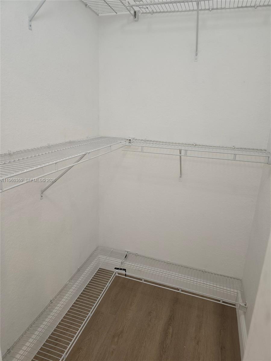 1575 Northeast 33rd Avenue, Unit 1049 Homestead, FL 33033 - Photo 16 of 22 a view of a room with racks on the wall
