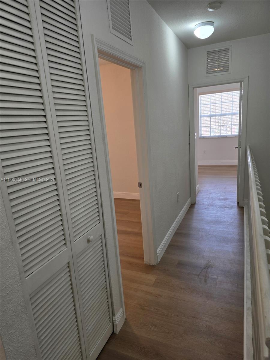 1575 Northeast 33rd Avenue, Unit 1049 Homestead, FL 33033 - Photo 18 of 22 a view of a hallway with wooden floor