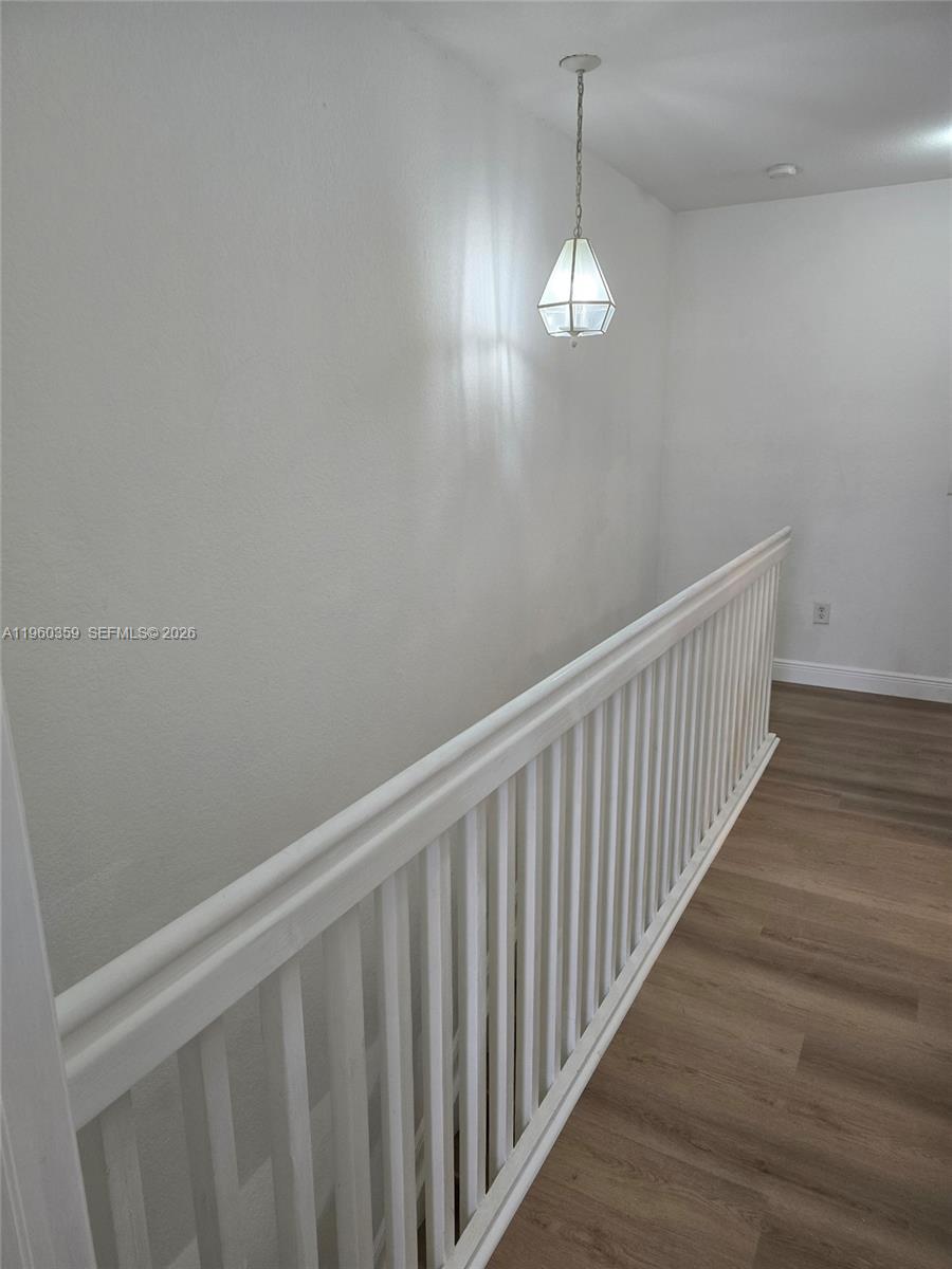 1575 Northeast 33rd Avenue, Unit 1049 Homestead, FL 33033 - Photo 19 of 22 a view of a hallway with wooden floor