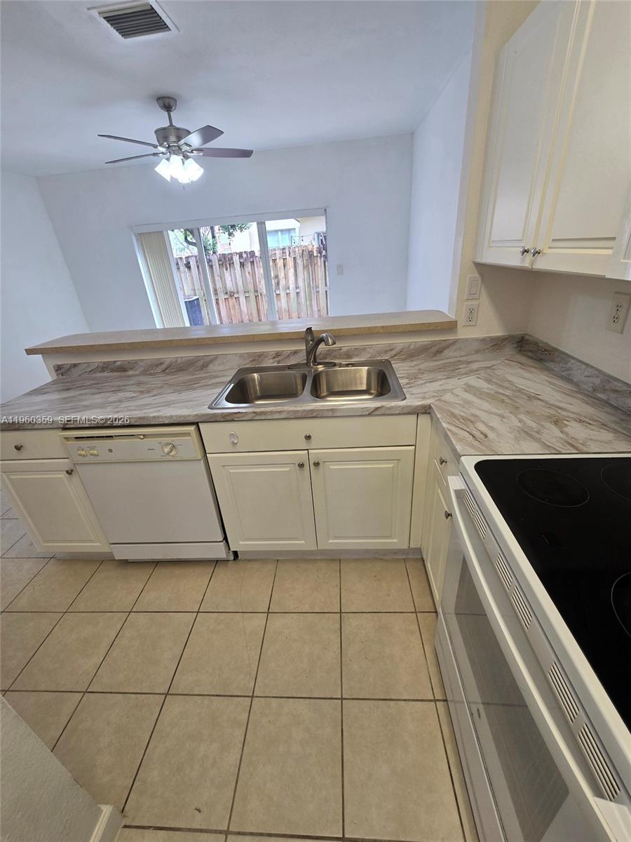 1575 Northeast 33rd Avenue, Unit 1049 Homestead, FL 33033 - Photo 4 of 22 a kitchen with a sink cabinets and window