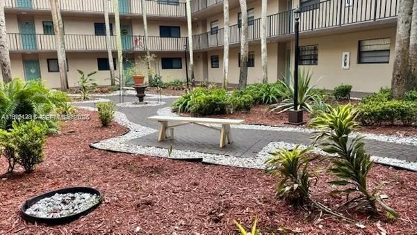 a view of a chair and table in back yard of a building