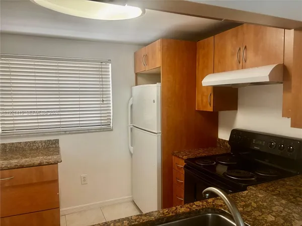 a kitchen with a stove and a refrigerator