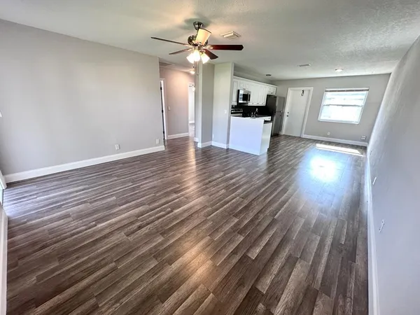 wooden floor in an empty room with a window