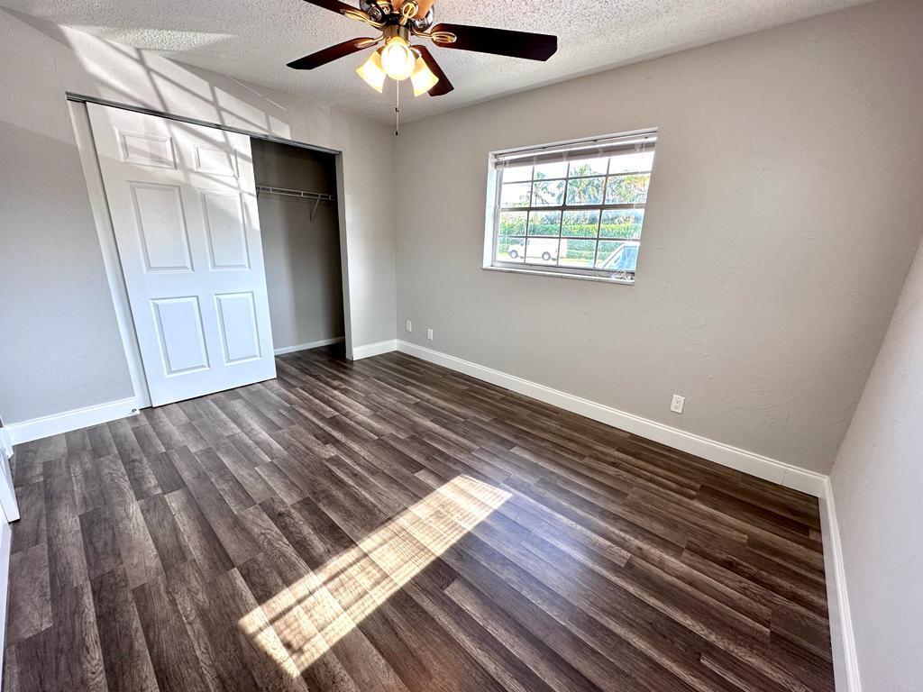 848 Center Street, Unit 3 Jupiter, FL 33458 - Photo 5 of 9 wooden floor in an empty room with a window