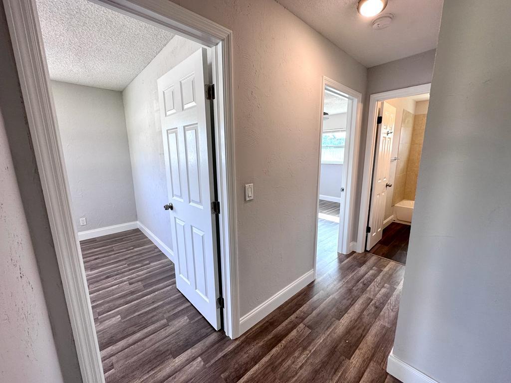 848 Center Street, Unit 3 Jupiter, FL 33458 - Photo 9 of 9 a view of a hallway with wooden floor and staircase