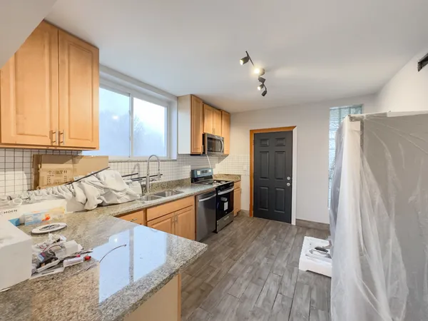 a kitchen with a refrigerator a sink and a stove
