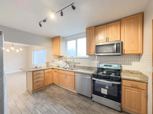 a kitchen with a sink stove top oven and cabinets