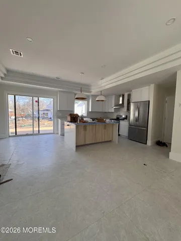 a view of a livingroom with furniture and an entryway