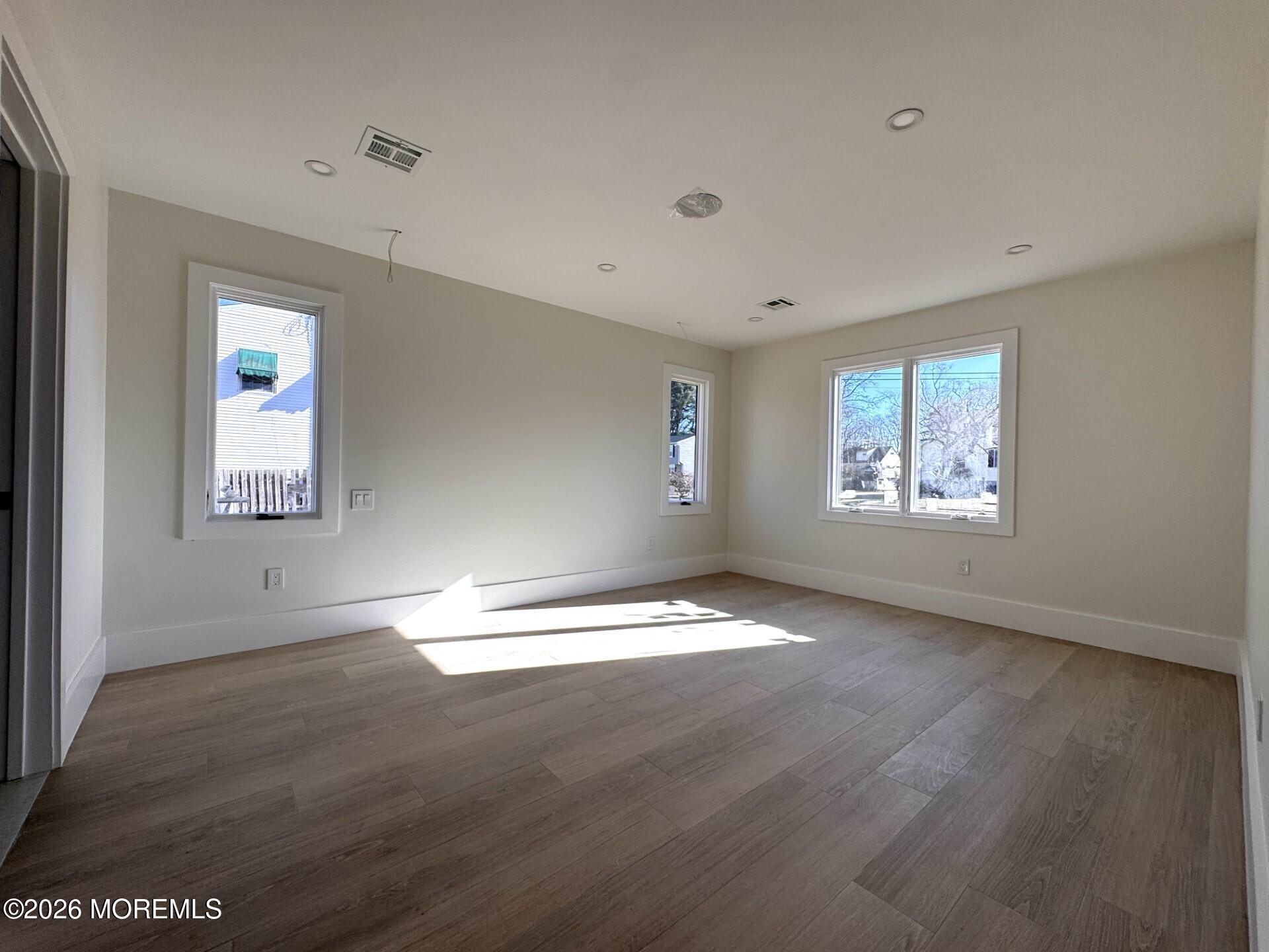 7 Whalepond Road Oakhurst, NJ 07755 - Photo 6 of 10 a view of empty room with wooden floor and fan