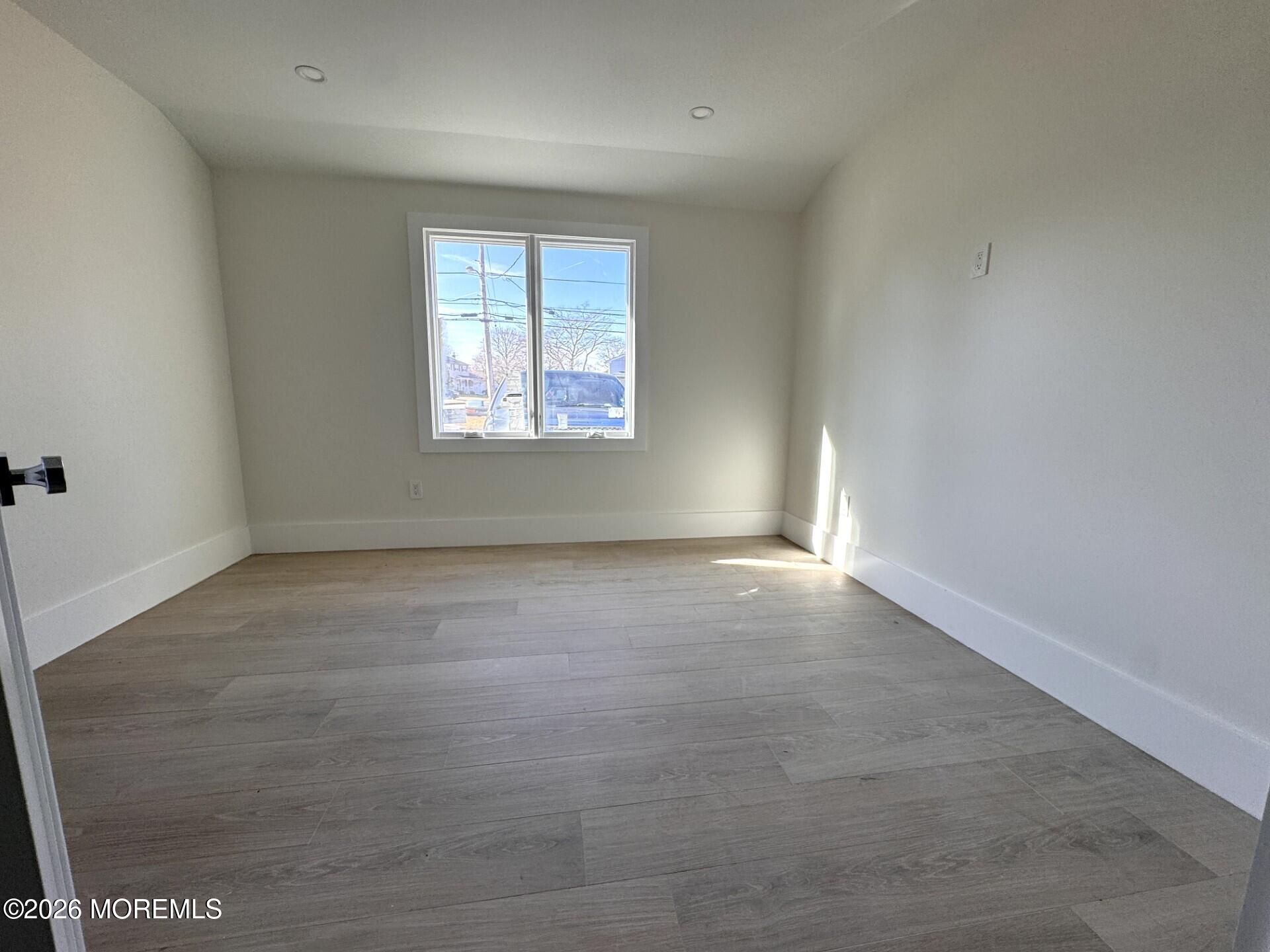 7 Whalepond Road Oakhurst, NJ 07755 - Photo 7 of 10 an empty room with windows