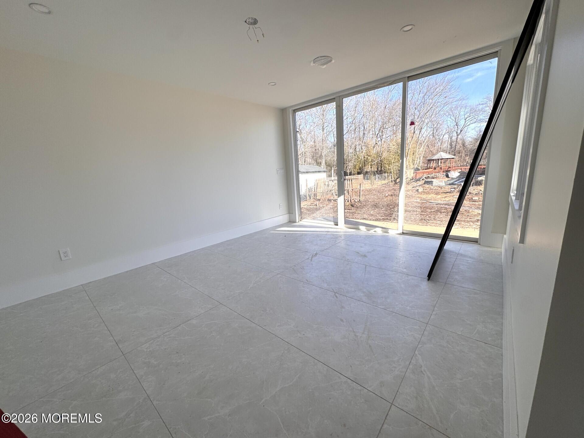 7 Whalepond Road Oakhurst, NJ 07755 - Photo 8 of 10 a view of an empty room with a sliding door