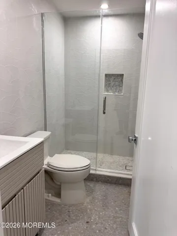 a bathroom with a toilet and a shower
