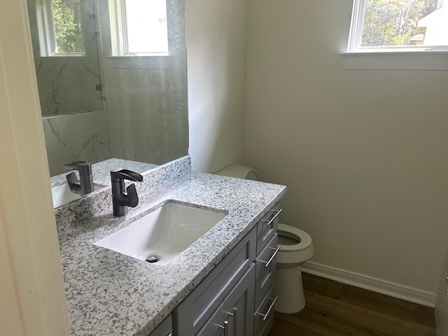 15010 Austin Road Willis, TX 77378 - Photo 15 of 22 a bathroom with a granite countertop sink a window and vanity