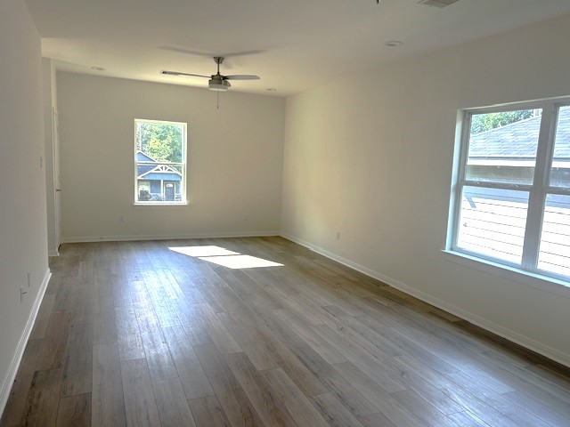 15010 Austin Road Willis, TX 77378 - Photo 2 of 22 an empty room with wooden floor and windows