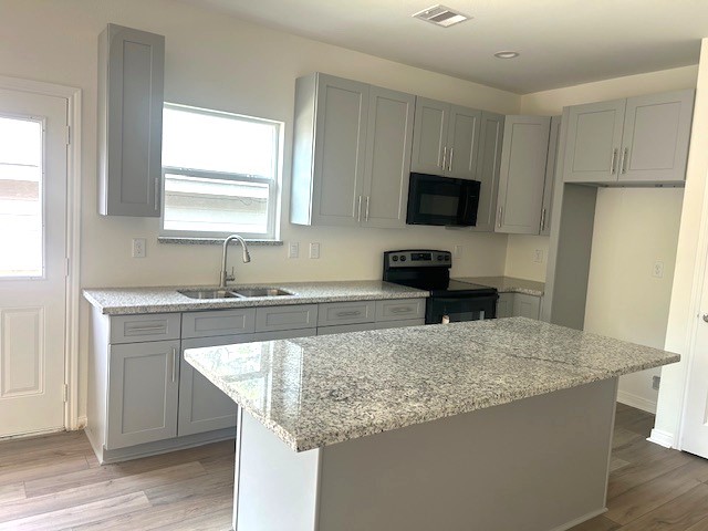 15010 Austin Road Willis, TX 77378 - Photo 3 of 22 a kitchen with granite countertop a sink and a stove top oven