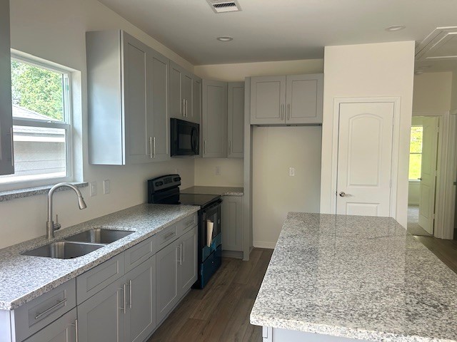 15010 Austin Road Willis, TX 77378 - Photo 4 of 22 a kitchen with a sink stove and refrigerator