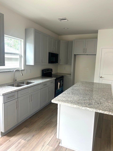 15010 Austin Road Willis, TX 77378 - Photo 7 of 22 a kitchen with sink cabinets and microwave