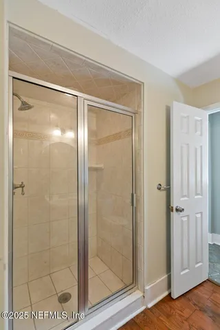 a bathroom with a glass shower door