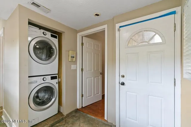 a view of a hallway with washer and dryer