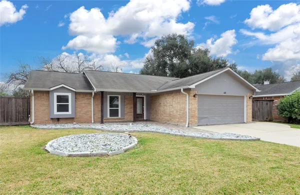 a front view of a house with a yard garage and outdoor seating