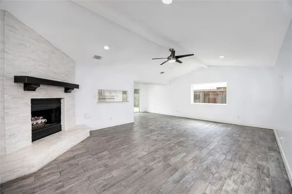 a view of an empty room with a fireplace