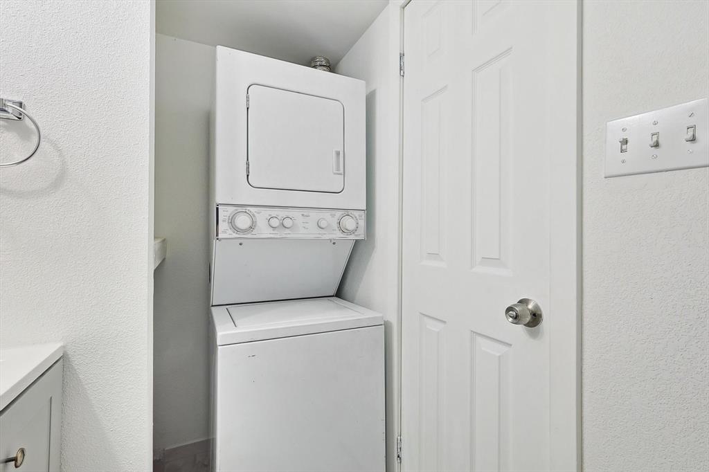 9805 Walnut Street, Unit 201 Dallas, TX 75243 - Photo 13 of 26 Clothes washing area featuring stacked washer / dryer