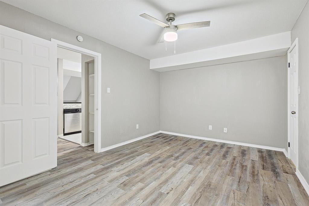 9805 Walnut Street, Unit 201 Dallas, TX 75243 - Photo 14 of 26 Spare room with ceiling fan and light hardwood / wood-style floors