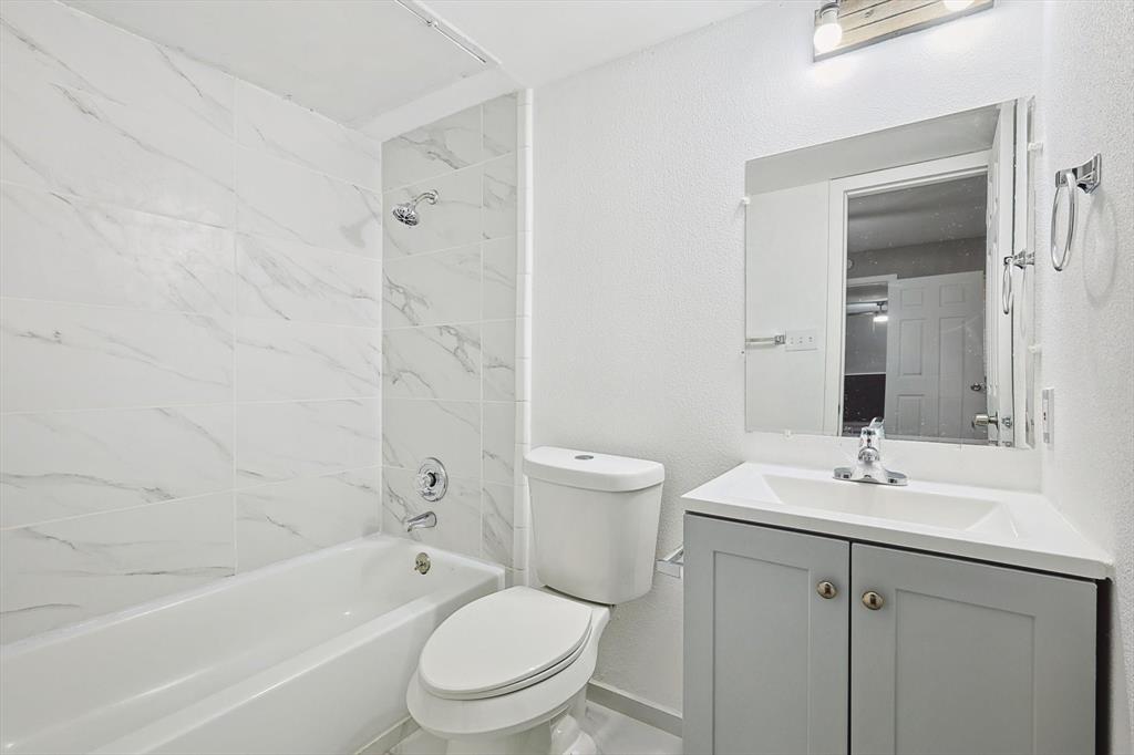 9805 Walnut Street, Unit 201 Dallas, TX 75243 - Photo 17 of 26 Full bathroom featuring tiled shower / bath combo, toilet, and vanity