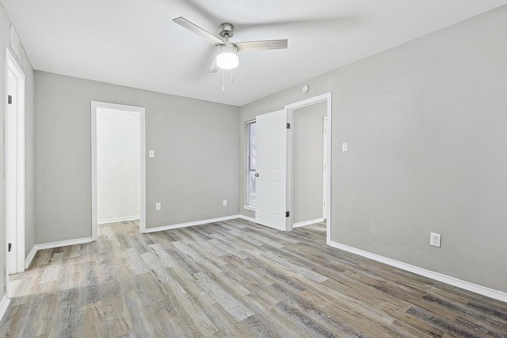 9805 Walnut Street, Unit 201 Dallas, TX 75243 - Photo 20 of 26 Spare room featuring wood-type flooring and ceiling fan