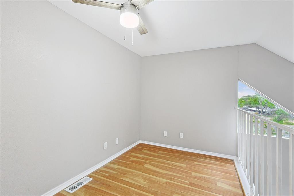 9805 Walnut Street, Unit 201 Dallas, TX 75243 - Photo 22 of 26 Empty room with ceiling fan, light wood-type flooring, and lofted ceiling