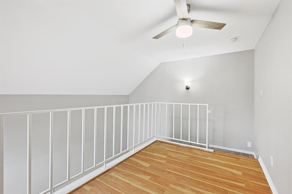 9805 Walnut Street, Unit 201 Dallas, TX 75243 - Photo 23 of 26 Bonus room featuring lofted ceiling, light wood-type flooring, and ceiling fan