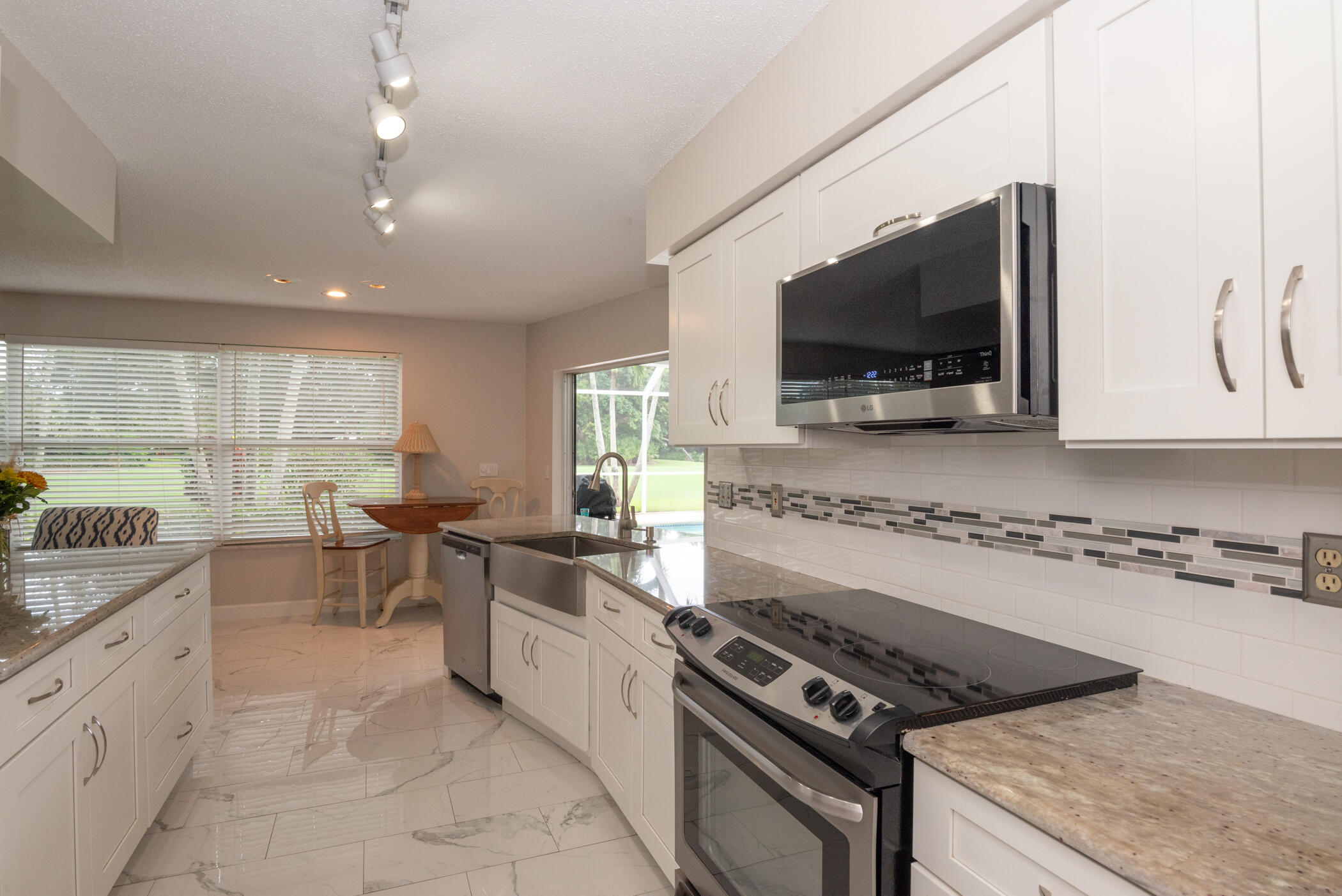 2811 Southeast Fairway West Stuart, FL 34997 - Photo 14 of 40 a kitchen with stove and cabinets