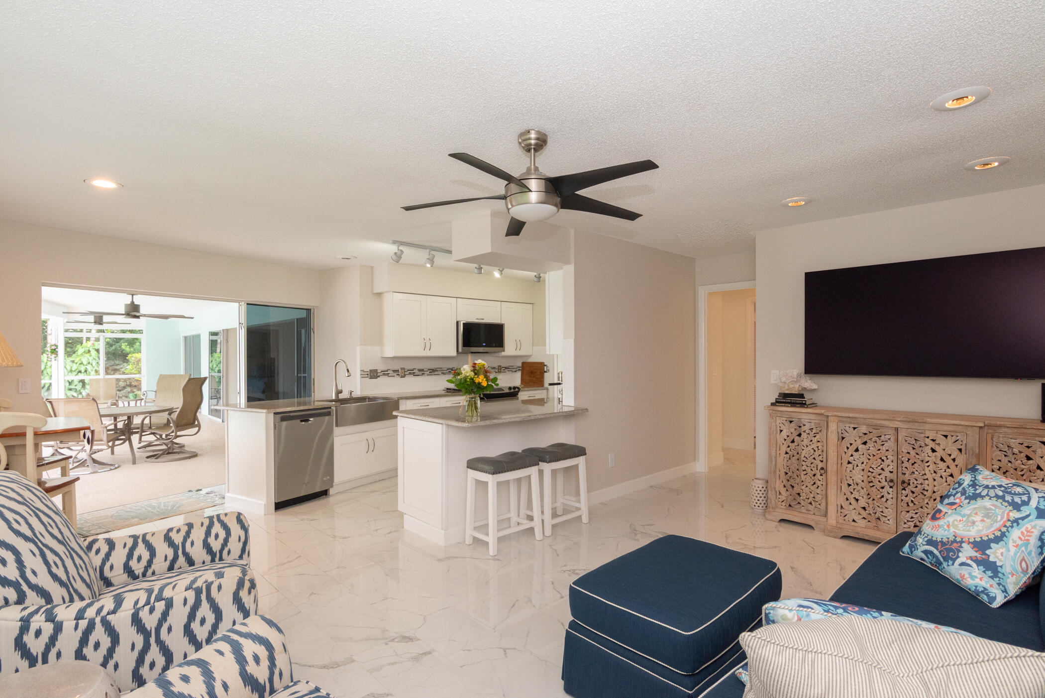 2811 Southeast Fairway West Stuart, FL 34997 - Photo 17 of 40 a living room with furniture and a flat screen tv
