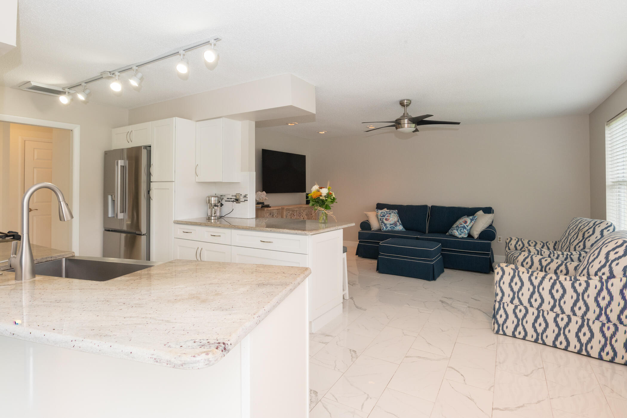 2811 Southeast Fairway West Stuart, FL 34997 - Photo 18 of 40 a kitchen with a refrigerator and a sink