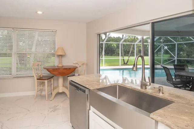 a kitchen with a sink and a large window