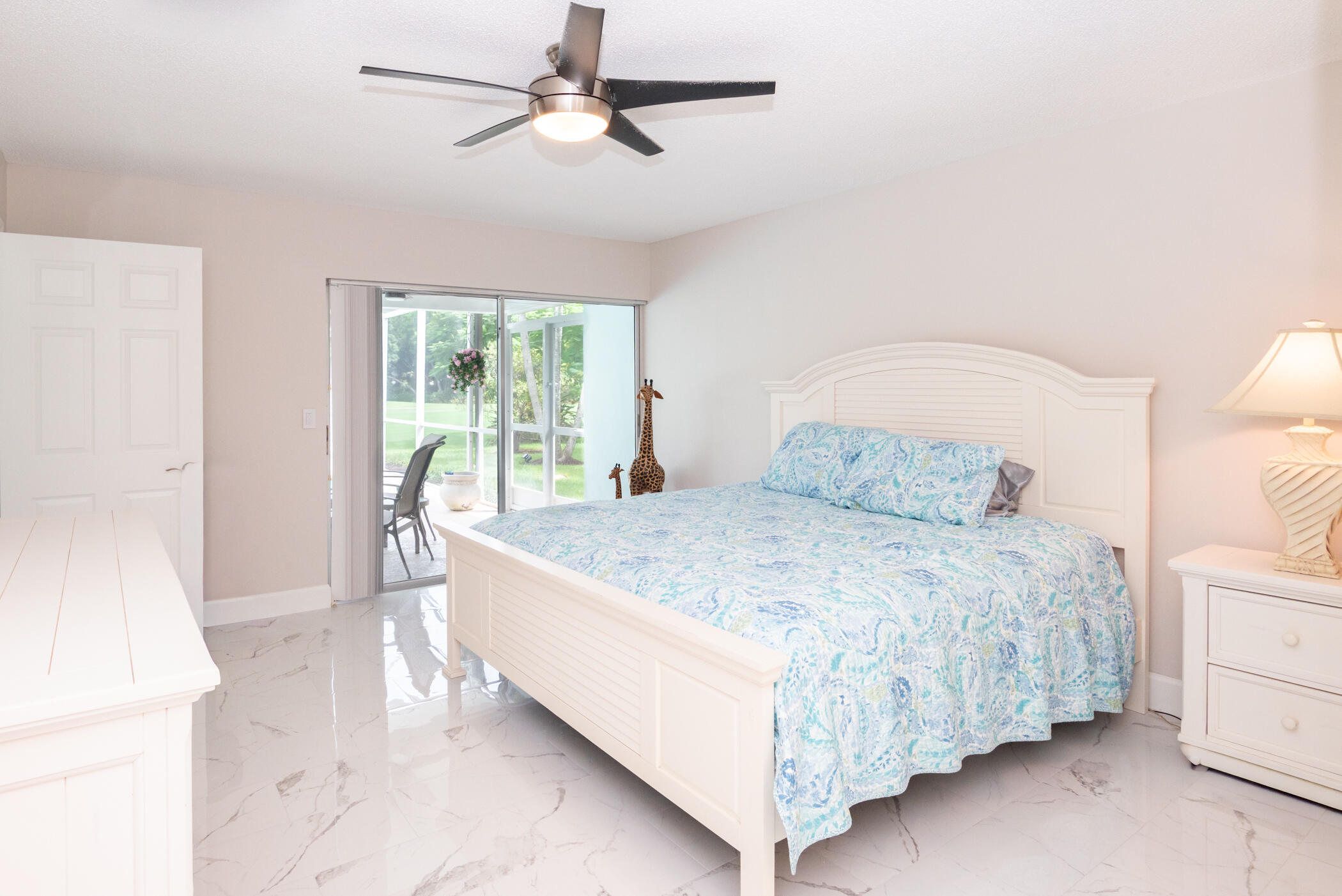 2811 Southeast Fairway West Stuart, FL 34997 - Photo 24 of 40 a bed sitting in a bedroom next to a window