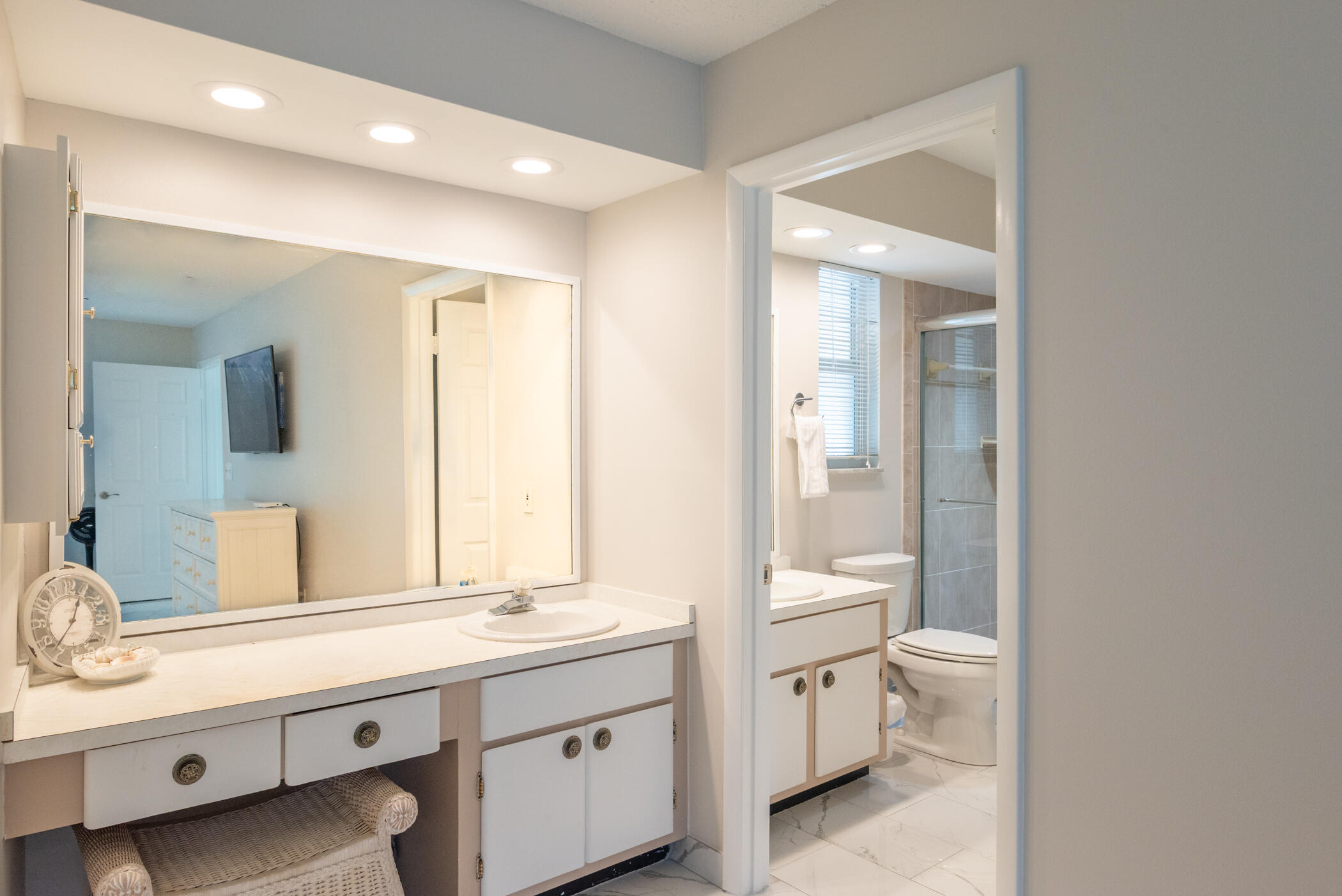 2811 Southeast Fairway West Stuart, FL 34997 - Photo 25 of 40 a bathroom with a double vanity sink toilet and a mirror